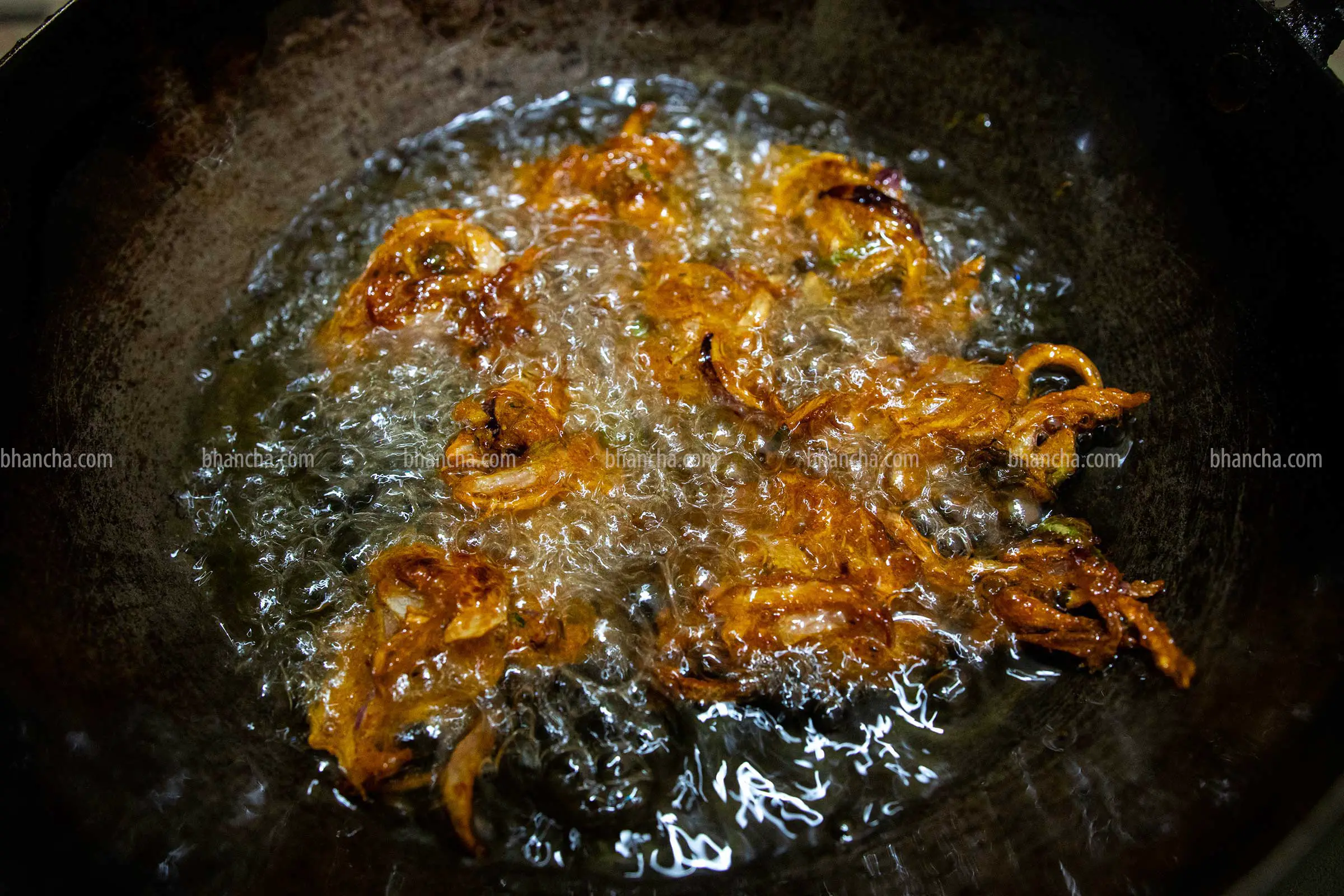 frying onion pakora until golden 